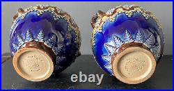 A PAIR OF ANTIQUE DOULTON LAMBETH WARE URNS By Elizabeth Atkins. Height 14cm