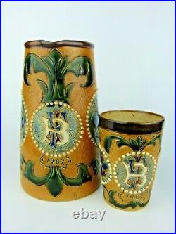 A Superb Fulham Pottery Stoneware Jug and Beaker Set. Monogrammed and Dated 1902